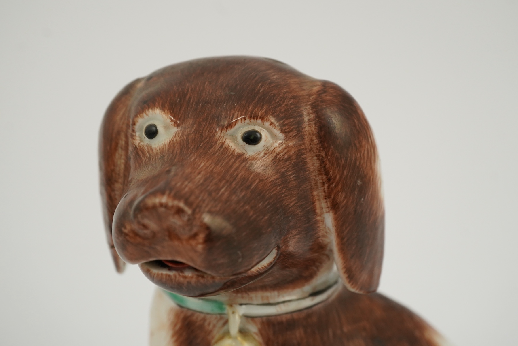A Chinese export enamelled porcelain model of a seated spaniel, Qianlong period
